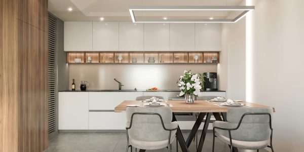 Modern apartment dining room interior with kitchen counter with marble wall in the background. Big dining table with orange chairs, wooden walls with mirror, parquet, pendant lamps and white ceiling. Template for copy space. Render.